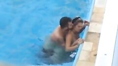 Desiring couple makes sexual intercourse in public swimming pool while hidden voyeur records